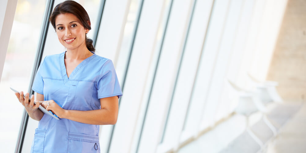 A nurse on the stairs with healthcare workers in the background
