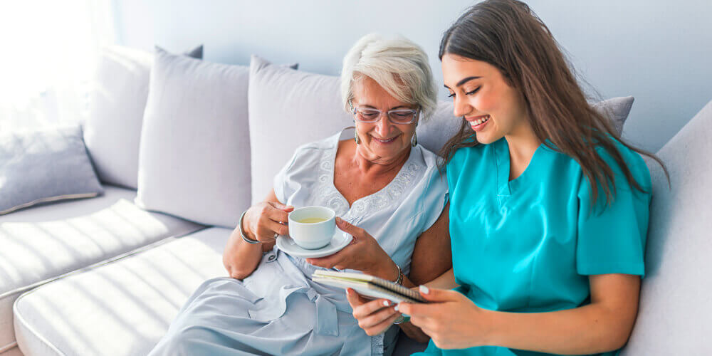 A mental health nurse delivering in-home care to an elderly woman.