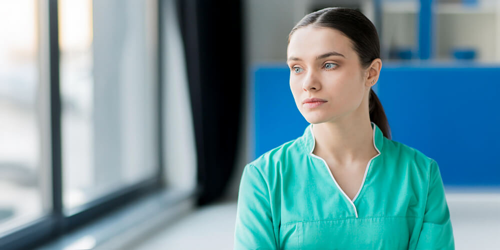 Nursing staff communicates with other care workers during a meeting.