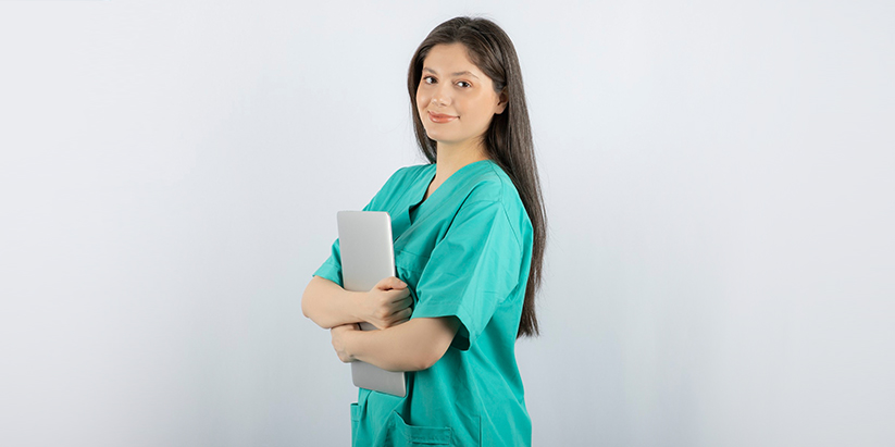 A nurse showing the value of nursing education by holding a pen and paper.