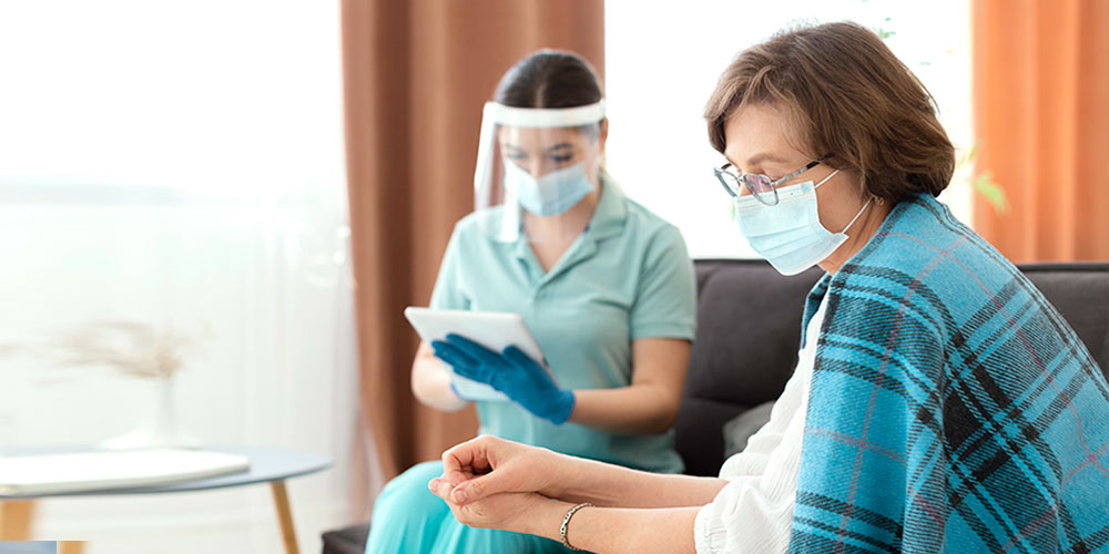 A nurse examines a patient's advanced clinical report on a screen.