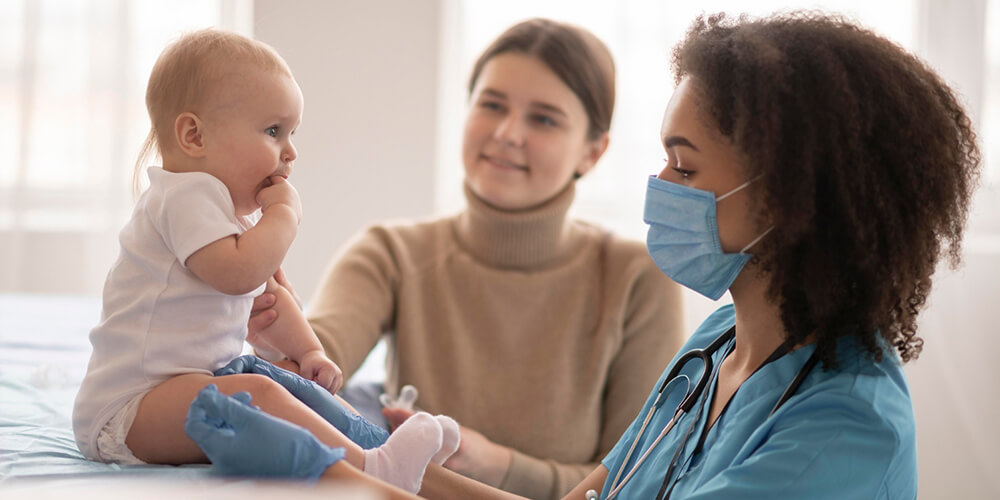 Infant receiving expert neonatal nursing care from a nurse