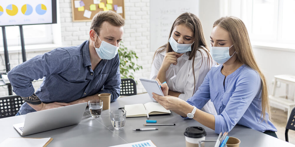 A healthcare team assessing the risk in the setting in a conference room.